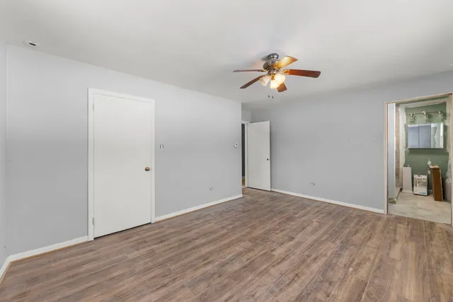 an empty room with closet and windows
