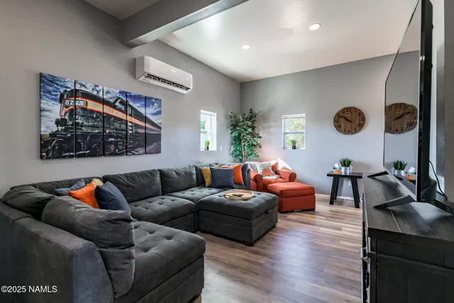 a view of a workspace with furniture and wooden floor