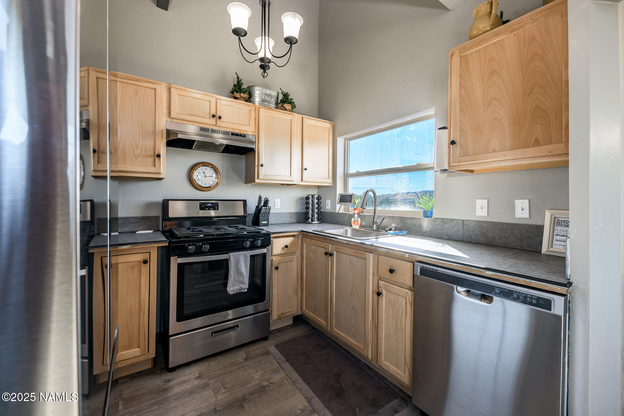 224 East San Marcos Road Williams, AZ 86046 - Photo 18 of 58 a kitchen with stainless steel appliances a sink and cabinets