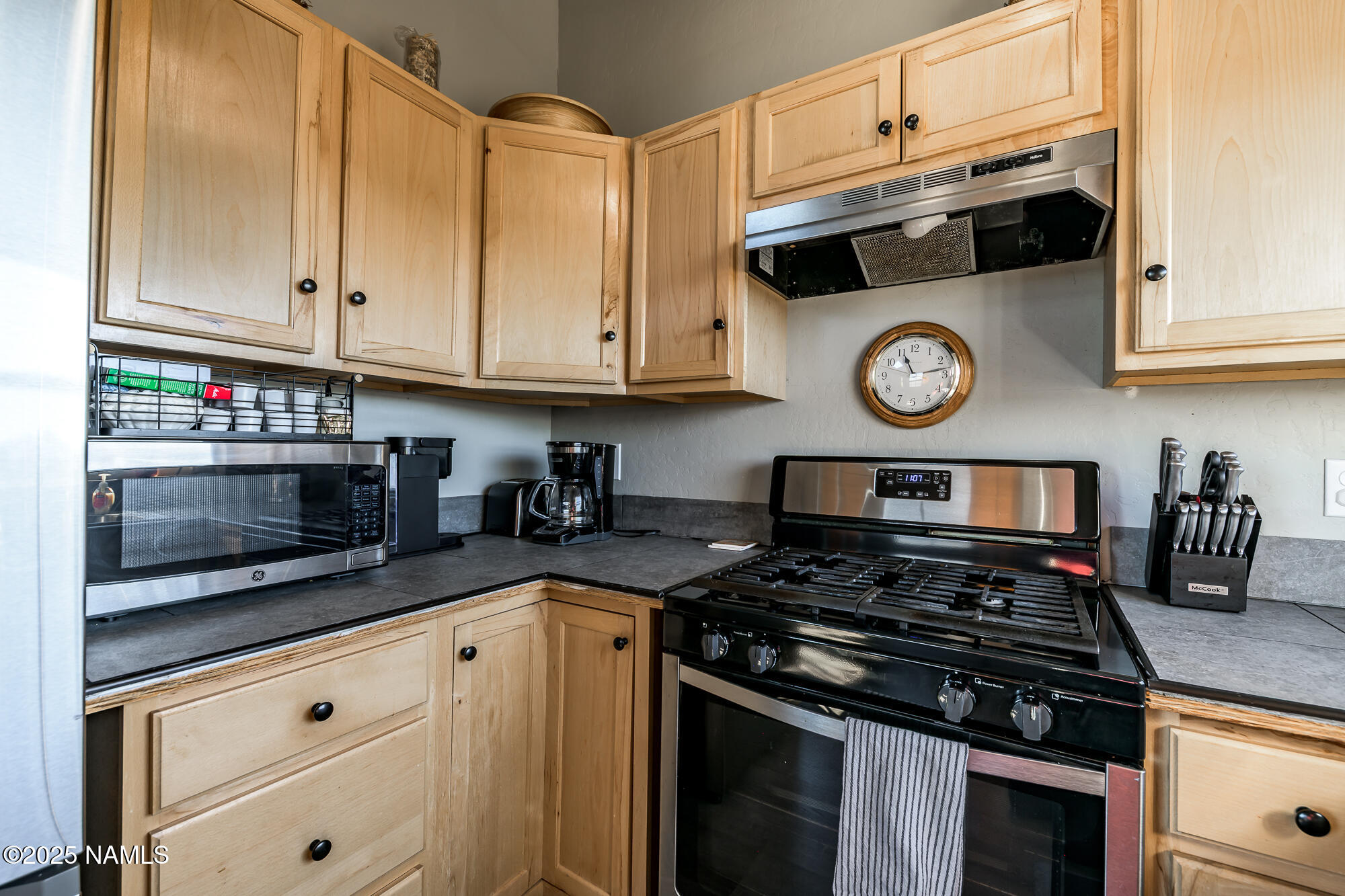 224 East San Marcos Road Williams, AZ 86046 - Photo 21 of 58 a kitchen with stainless steel appliances granite countertop a stove and a microwave