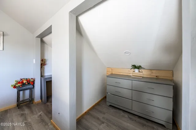 a bedroom with a bed and a dresser with mirror