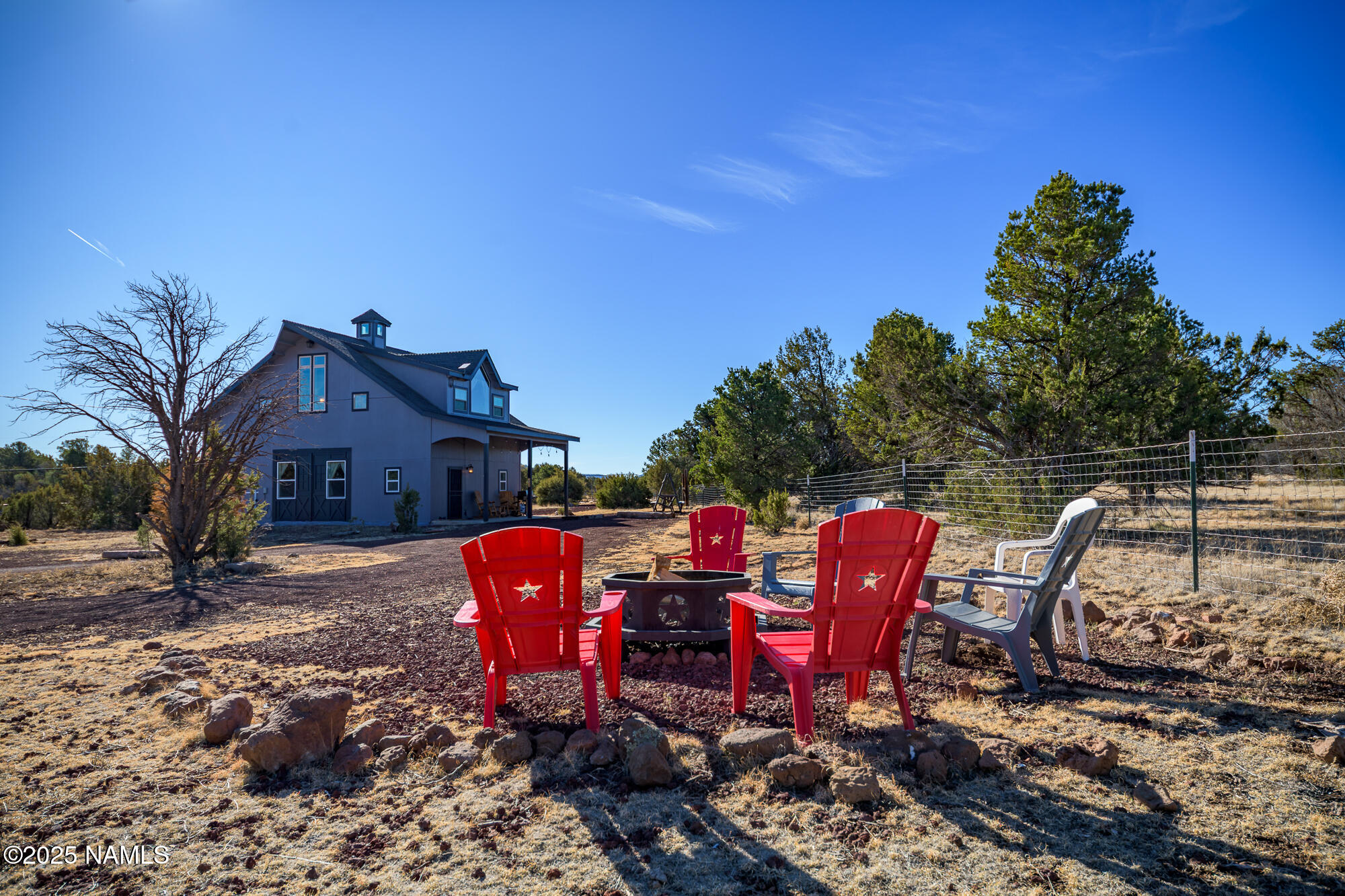 224 East San Marcos Road Williams, AZ 86046 - Photo 5 of 58 a view of a wooden chairs and table in the backyard