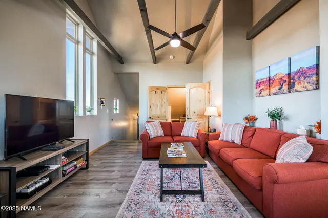 a living room with furniture and a potted plant