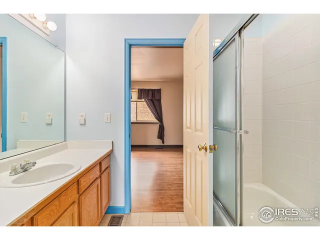 a bathroom with a sink a mirror and a shower