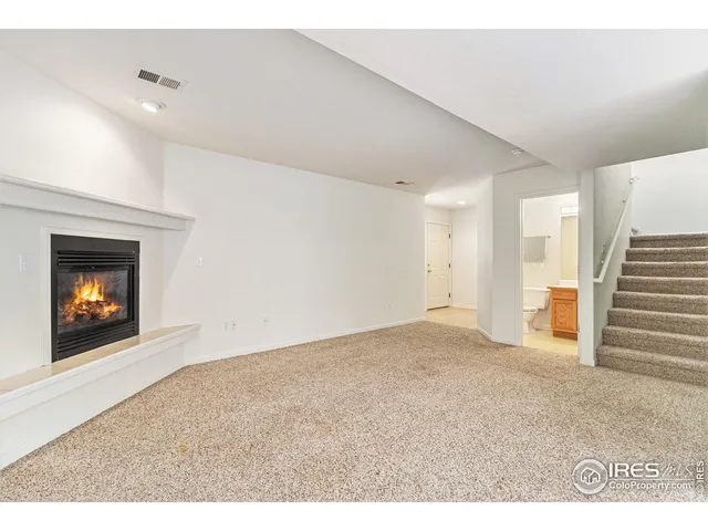 a view of an empty room with a fireplace
