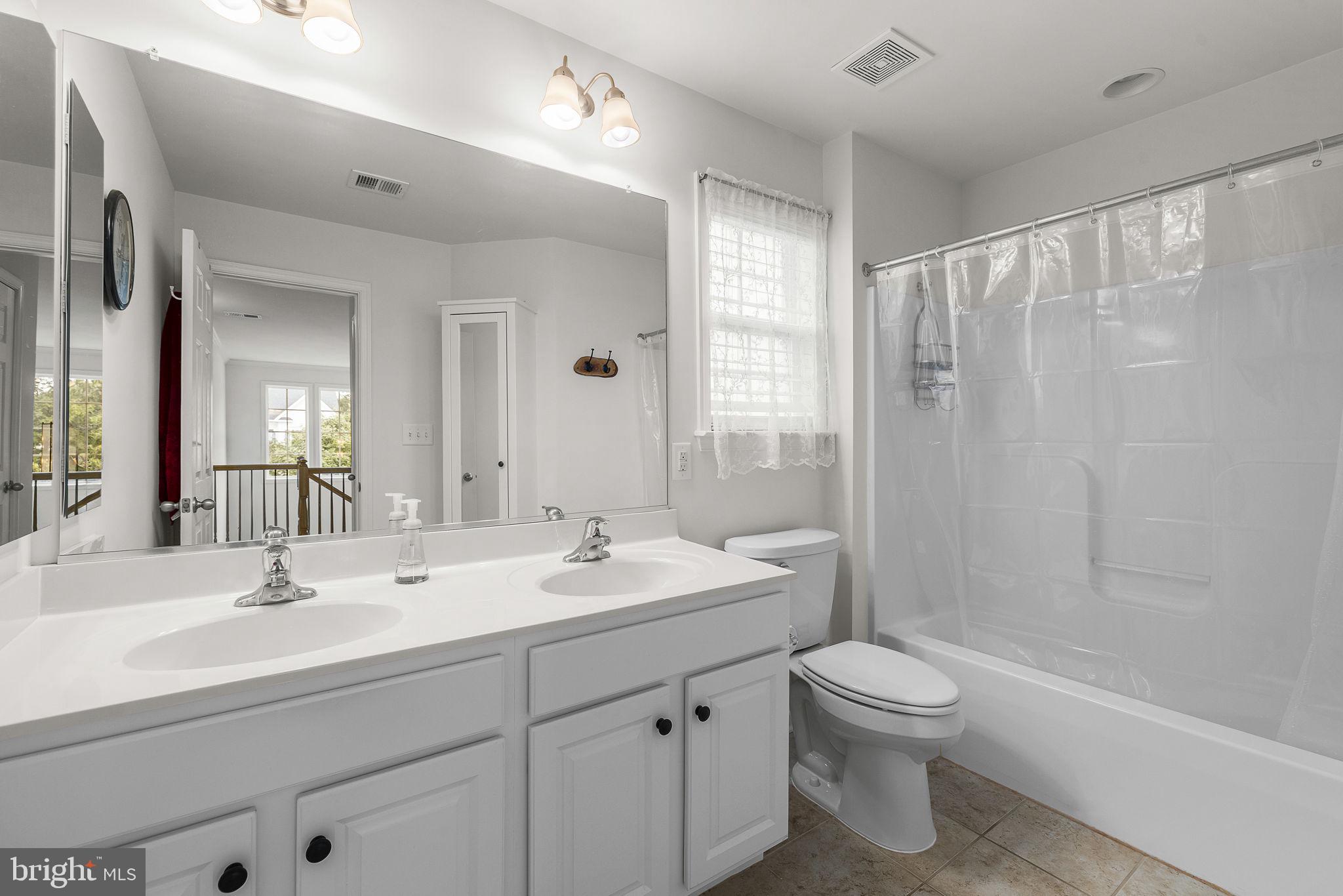 192 Matchbox Court Ranson, WV 25438 - Photo 23 of 50 a bathroom with a double vanity sink toilet and shower