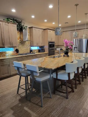 a kitchen with a table chairs refrigerator and microwave