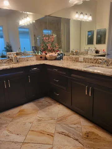 a bathroom with a sink vanity and a mirror