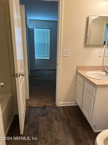 a view of backyard with wooden fence