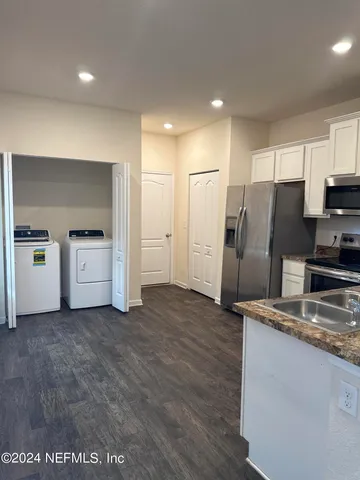 a kitchen with stainless steel appliances a refrigerator and a sink
