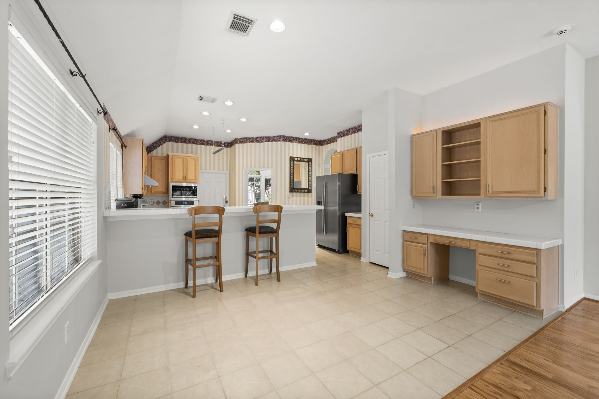 1614 Mercoal Drive Spring, TX 77386 - Photo 17 of 50 This versatile dining space features a built-in desk, making it ideal for meals, schoolwork, and family organization, all in one connected area.