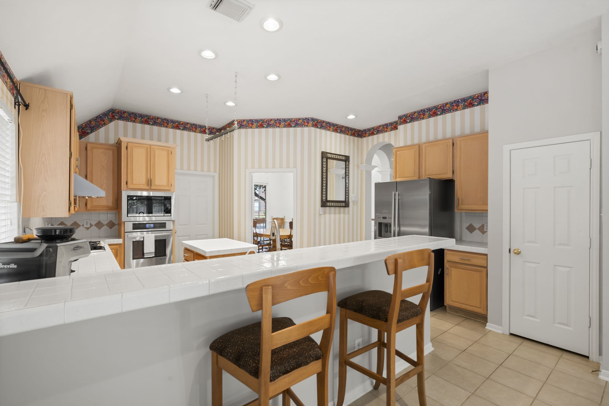 1614 Mercoal Drive Spring, TX 77386 - Photo 18 of 50 A spacious kitchen with a generous breakfast bar serves as the hub for family meals, quick snacks, and everyday gatherings.