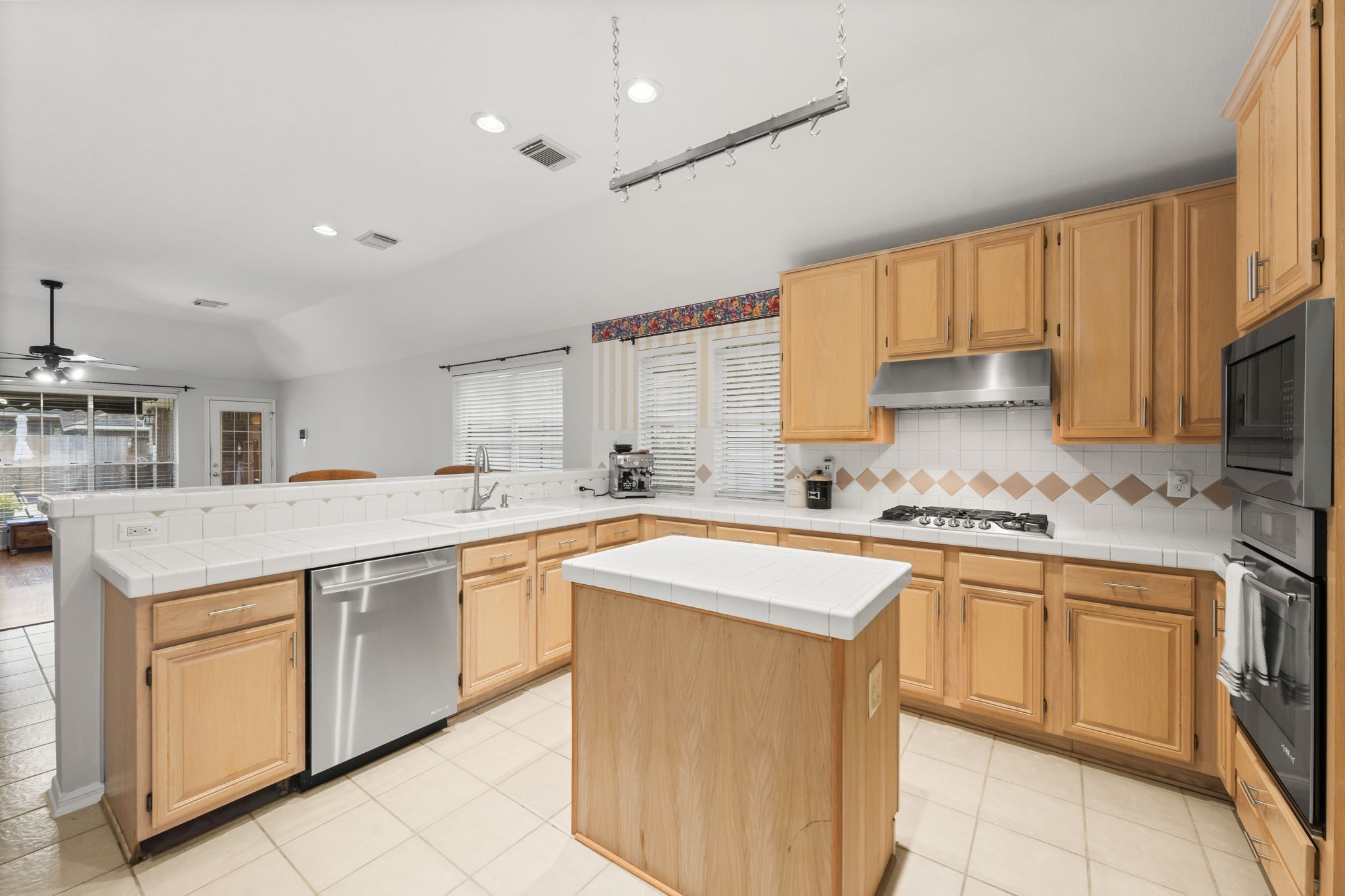 1614 Mercoal Drive Spring, TX 77386 - Photo 20 of 50 The kitchen’s open layout offers clear sightlines to the family room and dining area, making it easy to cook, serve, and spend time together.