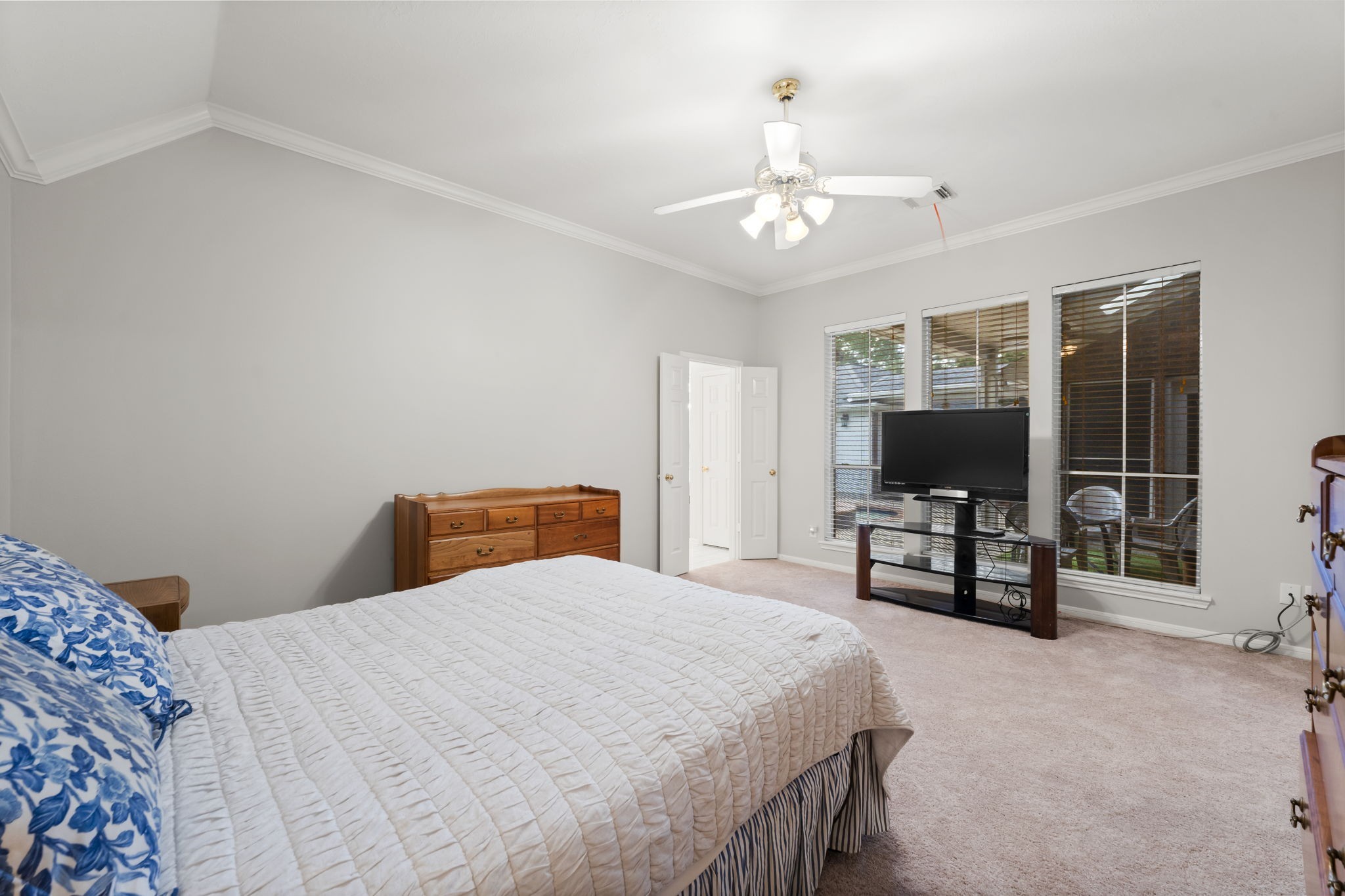 1614 Mercoal Drive Spring, TX 77386 - Photo 24 of 50 Wake up to views of the backyard, spa, and pool in this airy master bedroom, where high ceilings and natural light create a relaxing retreat just waiting for you to make it your own.