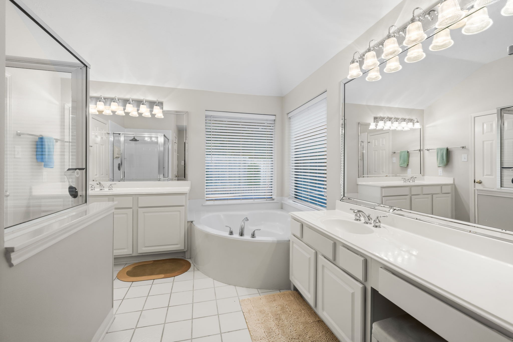 1614 Mercoal Drive Spring, TX 77386 - Photo 25 of 50 A thoughtfully designed bathroom with dual vanities and sinks, a large soaking tub, and separate shower provides convenience, comfort, and a touch of relaxation.