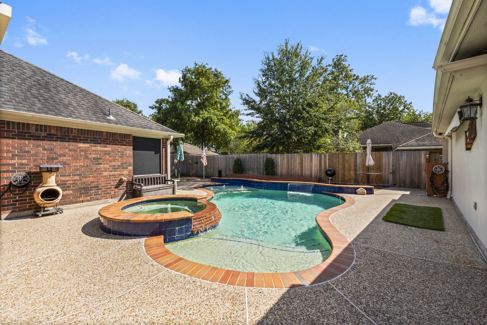 1614 Mercoal Drive Spring, TX 77386 - Photo 3 of 50 Step into a backyard oasis designed for relaxation and fun, featuring a heated saltwater pool and spa. This retreat-style setting offers a serene space to unwind, entertain, or enjoy sunny days with family and friends.