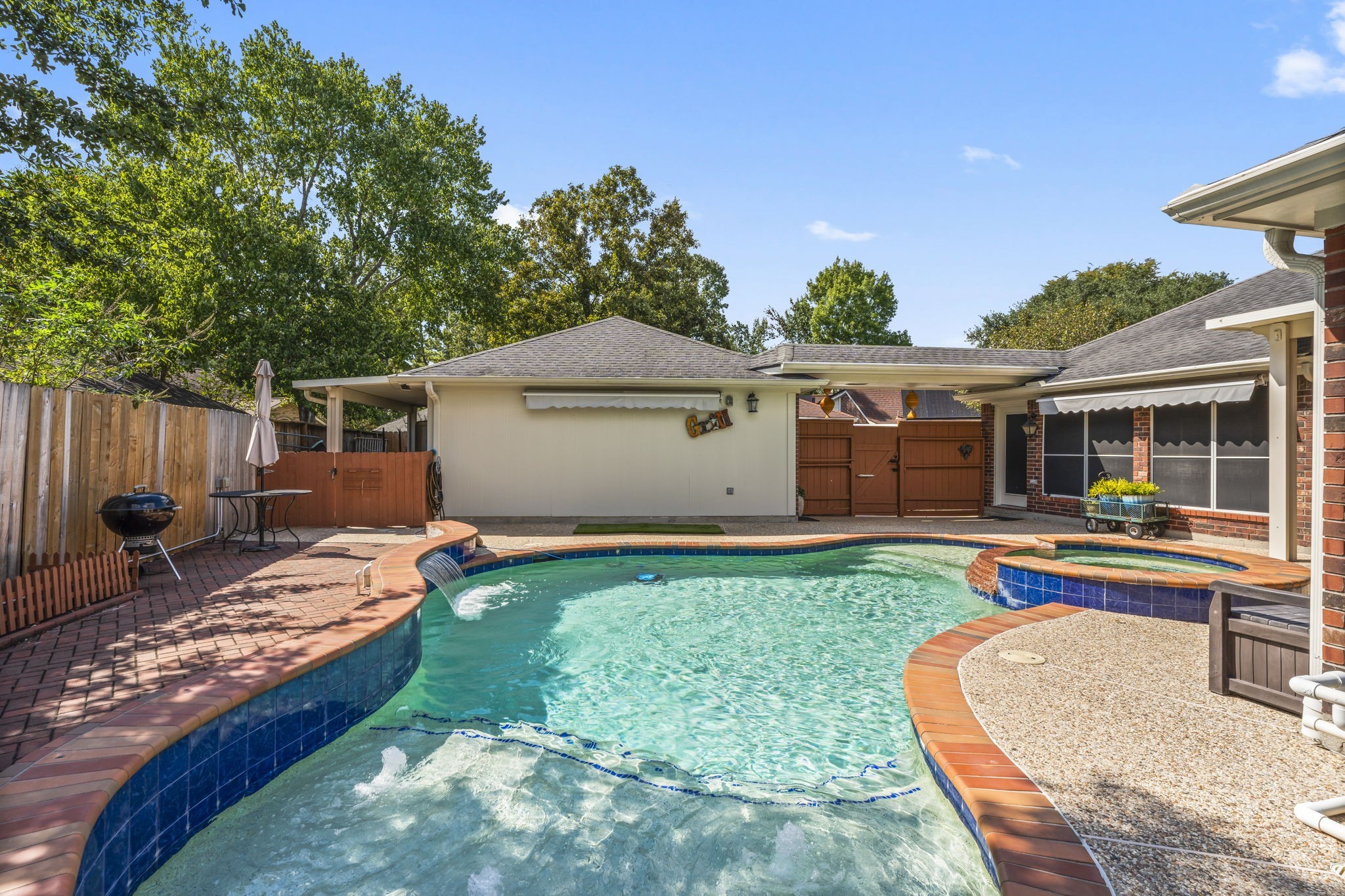 1614 Mercoal Drive Spring, TX 77386 - Photo 37 of 50 With a low-maintenance, remote-controlled pool and spa, you can enjoy the backyard retreat effortlessly, adjusting jets, waterfall, and temperature at the touch of a button.