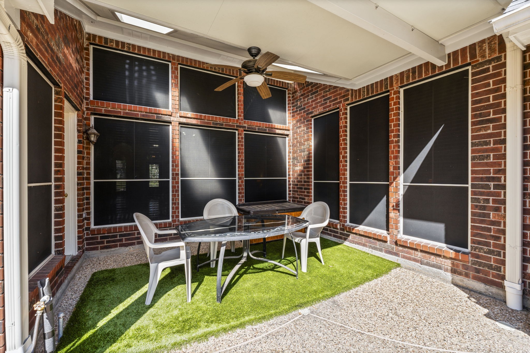 1614 Mercoal Drive Spring, TX 77386 - Photo 40 of 50 This shaded patio dining area overlooks the backyard, providing a comfortable spot to enjoy meals while watching the kids play in the pool or relax in the spa.