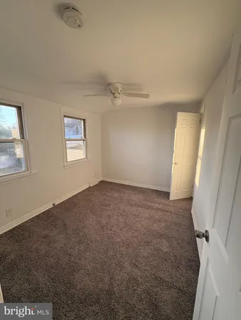 a view of a big room with windows and closet