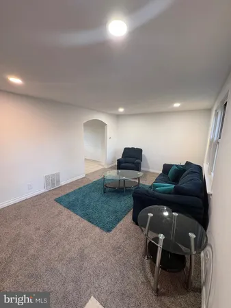a living room with furniture and a rug
