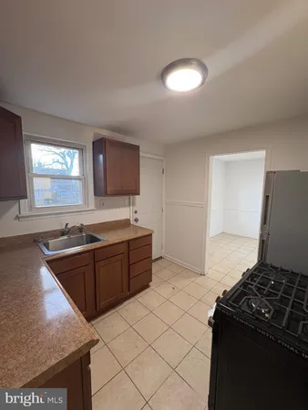 a kitchen with granite countertop a stove and a sink