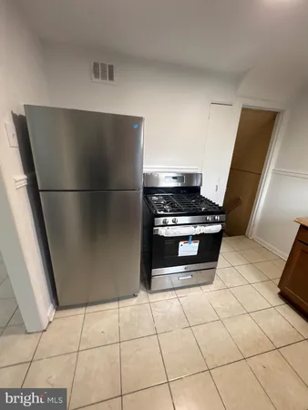 a kitchen with a stove and a refrigerator