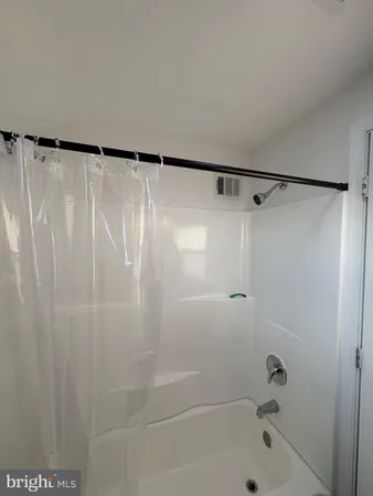 a bathroom with a shower and a bath tub