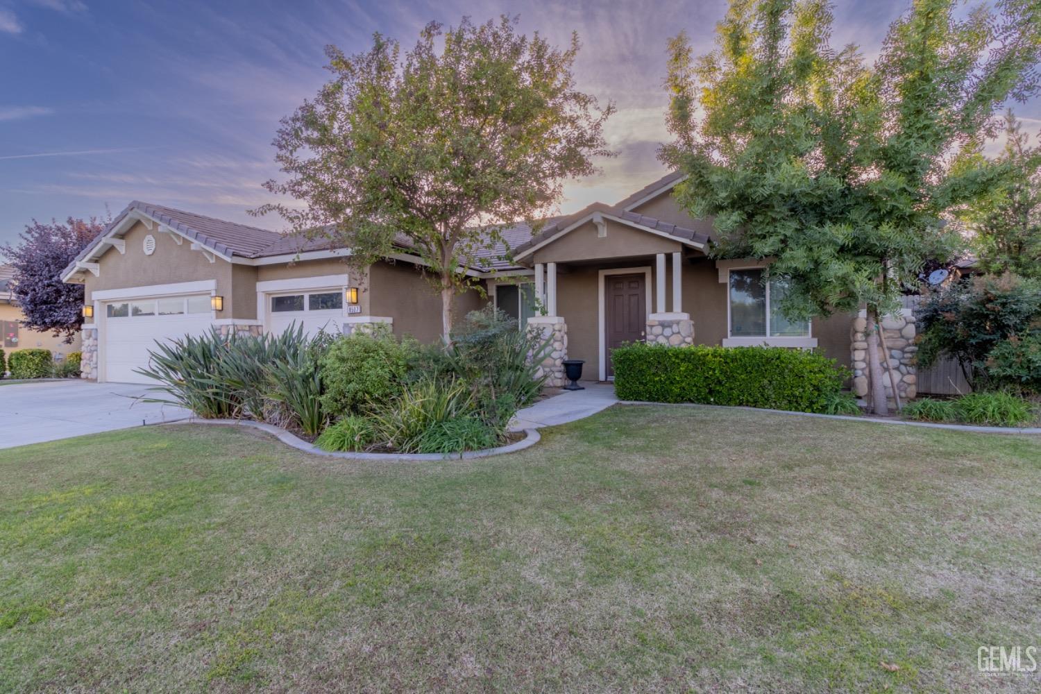 Undisclosed Address Bakersfield, CA 93314 - Photo 2 of 47 a front view of a house with a garden