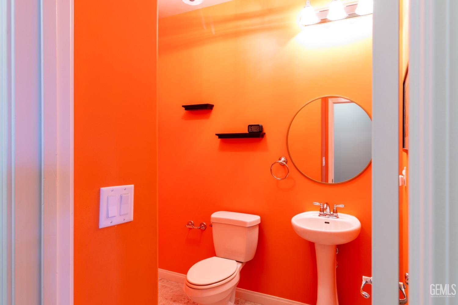 Undisclosed Address Bakersfield, CA 93314 - Photo 21 of 47 a bathroom with a toilet sink and mirror