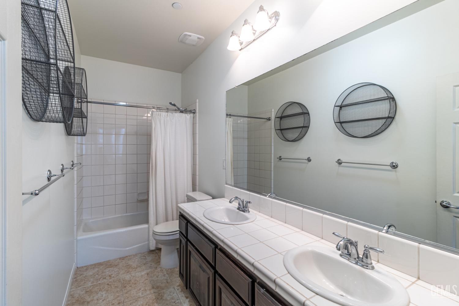 Undisclosed Address Bakersfield, CA 93314 - Photo 24 of 47 a bathroom with a sink a toilet and shower