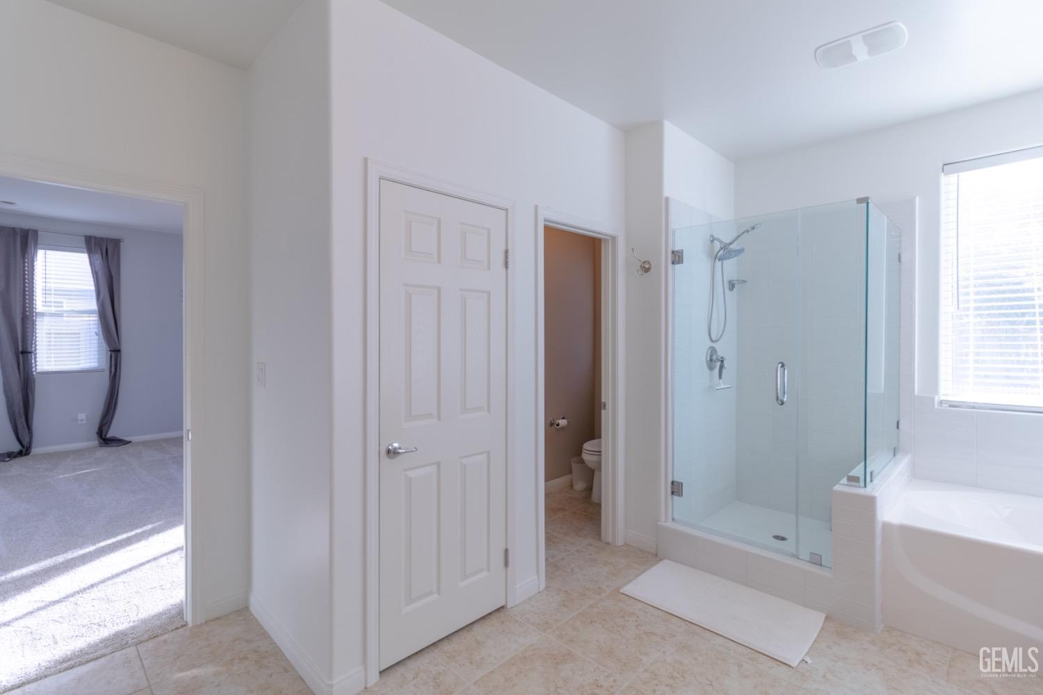 Undisclosed Address Bakersfield, CA 93314 - Photo 33 of 47 a spacious bathroom with a bathtub shower and a sink