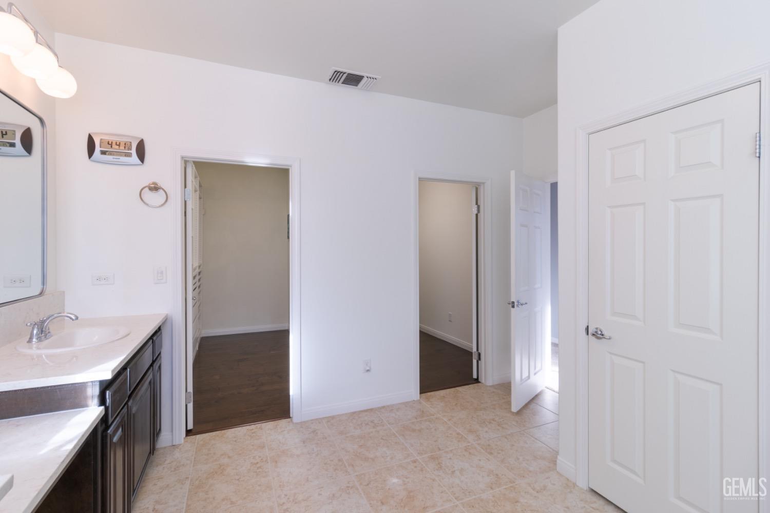 Undisclosed Address Bakersfield, CA 93314 - Photo 34 of 47 a view of a bathroom with a sink and mirror