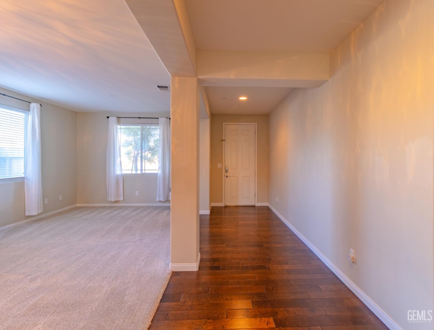 Undisclosed Address Bakersfield, CA 93314 - Photo 6 of 47 a view of an empty room with wooden floor and a window
