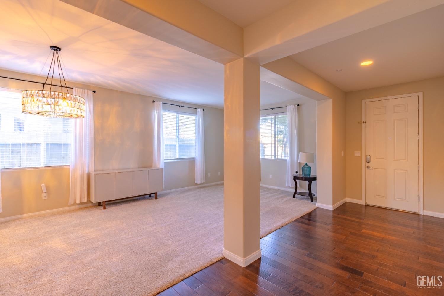 Undisclosed Address Bakersfield, CA 93314 - Photo 7 of 47 a view of an empty room with wooden floor and a window