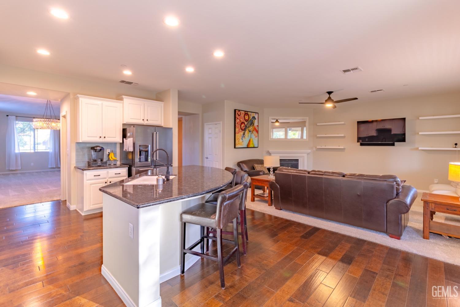 Undisclosed Address Bakersfield, CA 93314 - Photo 8 of 47 a living room with furniture a flat screen tv and kitchen view