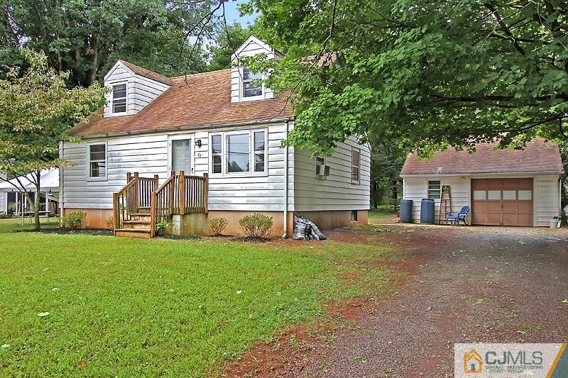 62 Wilson Road Somerset, NJ 08873 - Photo 1 of 14 a front view of a house with a garden and yard