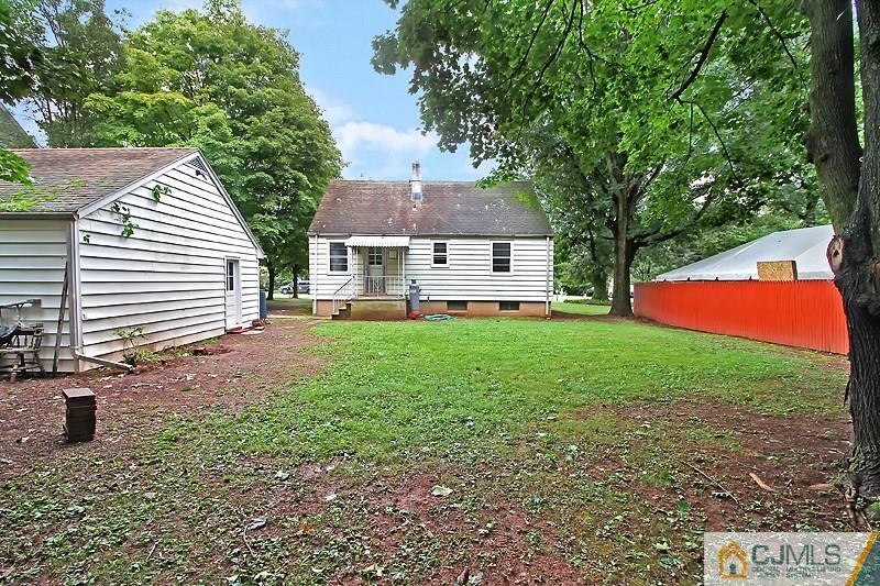 62 Wilson Road Somerset, NJ 08873 - Photo 3 of 14 a front view of a house with a yard and garage