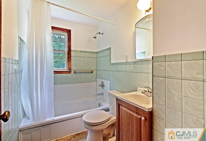 62 Wilson Road Somerset, NJ 08873 - Photo 5 of 14 a bathroom with a sink a toilet and shower
