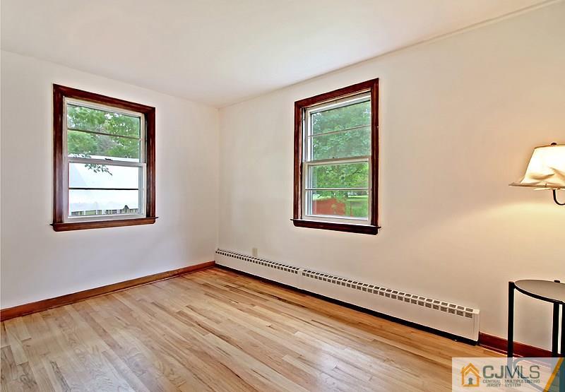 62 Wilson Road Somerset, NJ 08873 - Photo 6 of 14 wooden floor in an empty room with a window