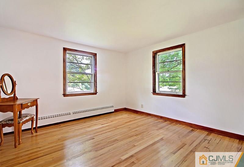 62 Wilson Road Somerset, NJ 08873 - Photo 7 of 14 an empty room with wooden floor and windows