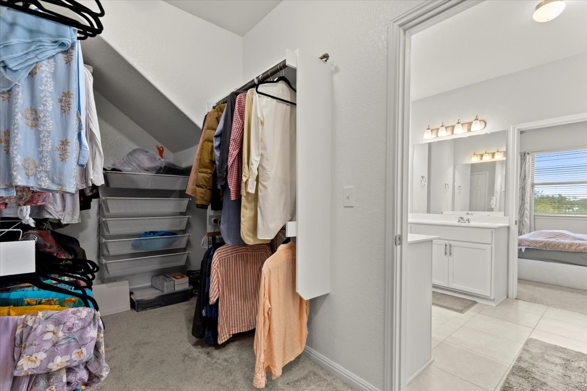 213 Munk Lane Leander, TX 78641 - Photo 17 of 40 a view of walk in closet with clothes and shoes