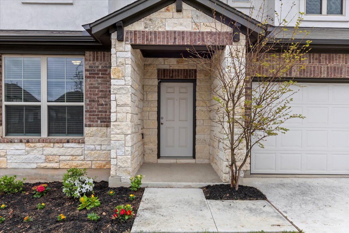 213 Munk Lane Leander, TX 78641 - Photo 2 of 40 a front view of a house with a garden
