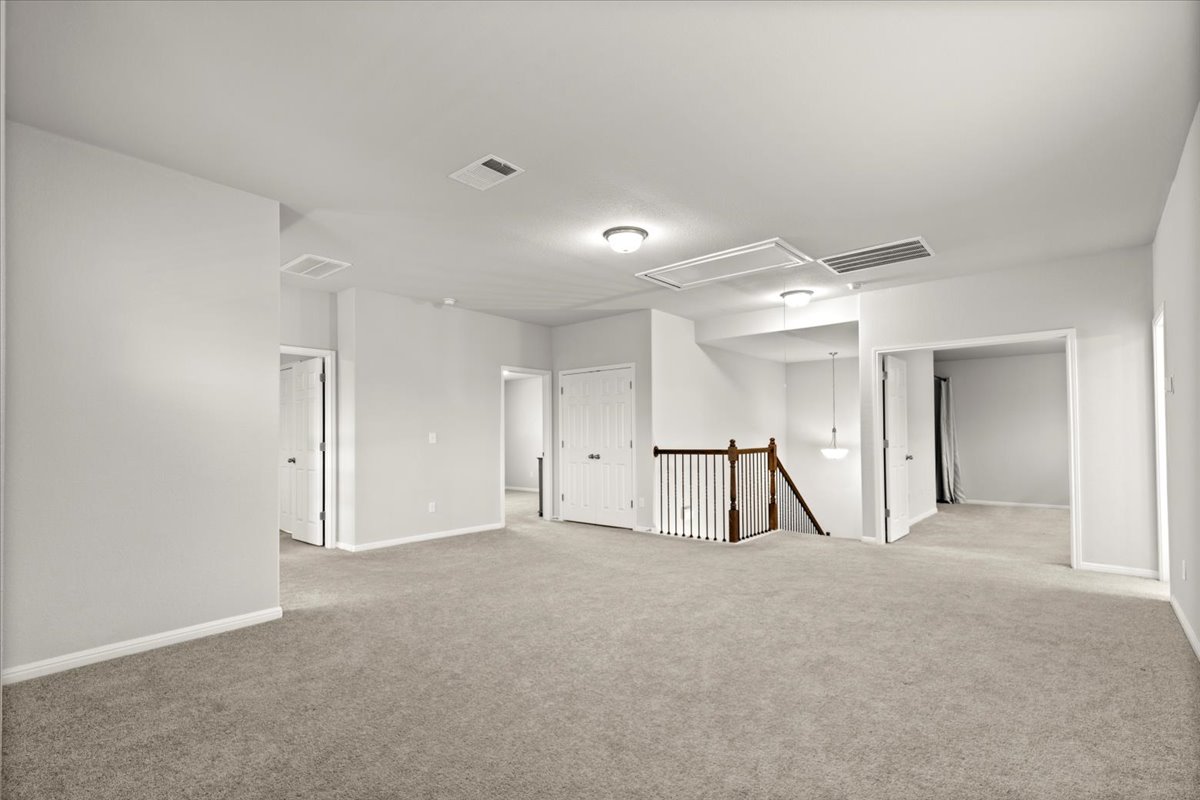 213 Munk Lane Leander, TX 78641 - Photo 20 of 40 Spare room featuring light carpet and attic access
