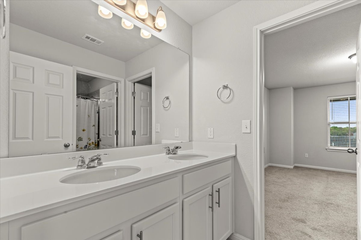 213 Munk Lane Leander, TX 78641 - Photo 28 of 40 a bathroom with a sink and a mirror