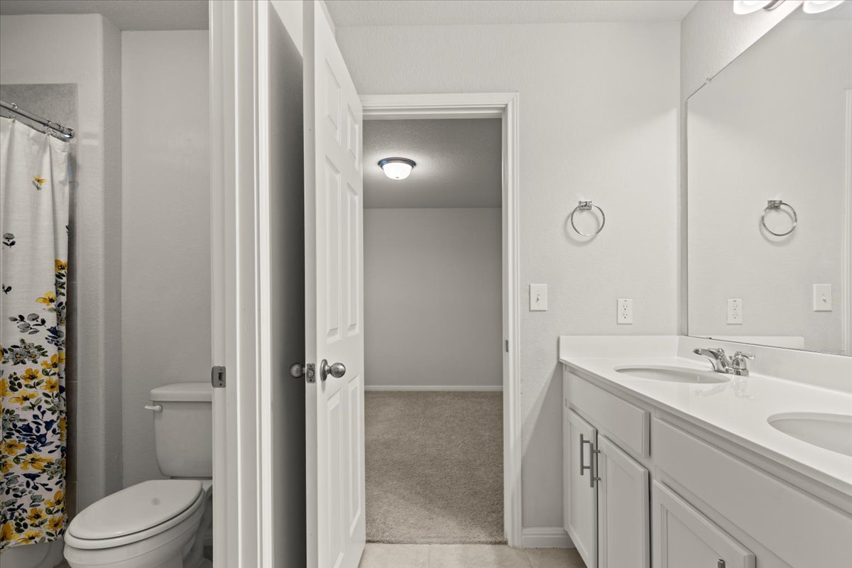 213 Munk Lane Leander, TX 78641 - Photo 29 of 40 a bathroom with a sink a toilet and shower