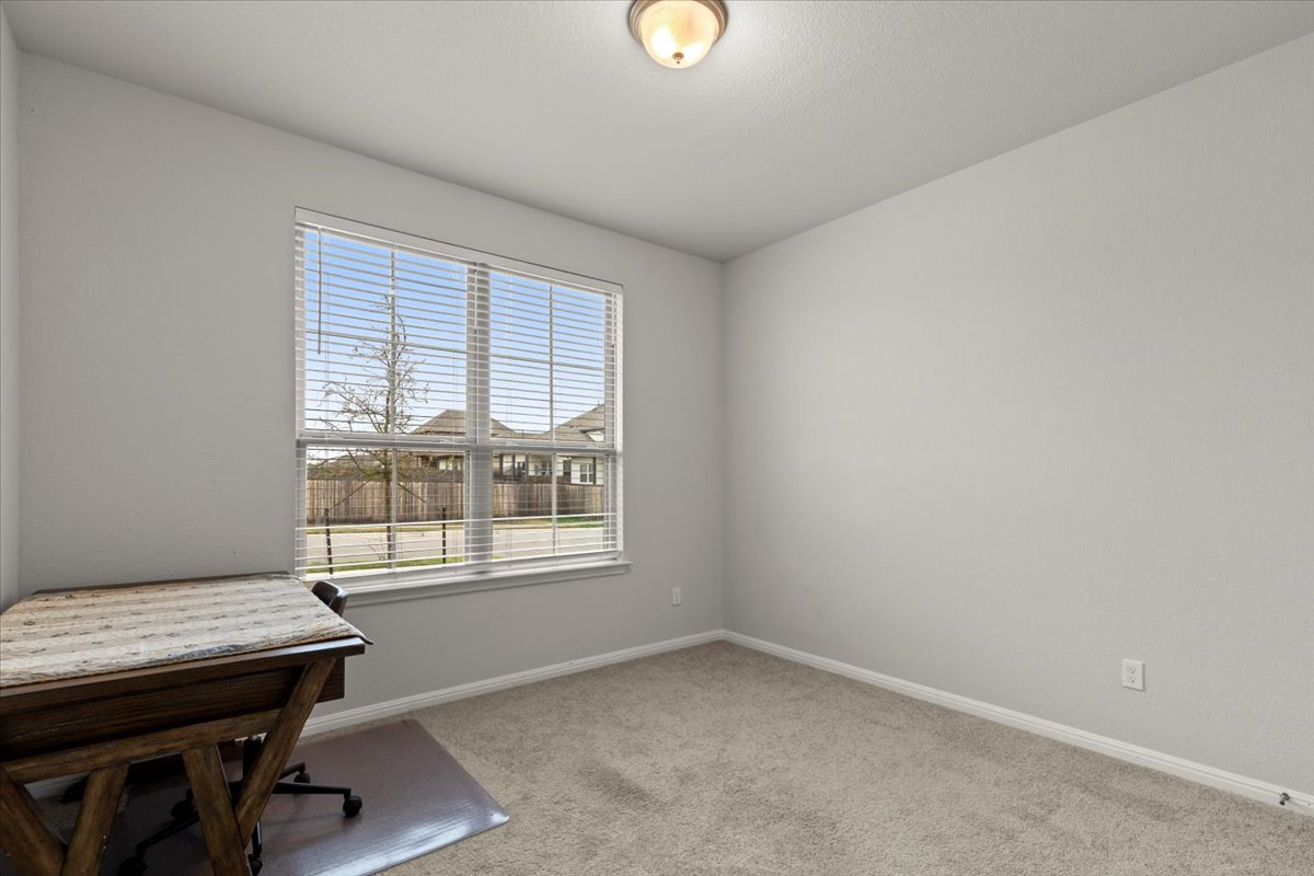 213 Munk Lane Leander, TX 78641 - Photo 31 of 40 Office area with light colored carpet and baseboards