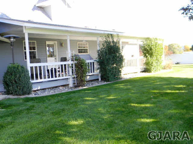 1181-17 17 1/2 Road Fruita, CO 81521 - Photo 11 of 38 a view of a house with a yard and a porch