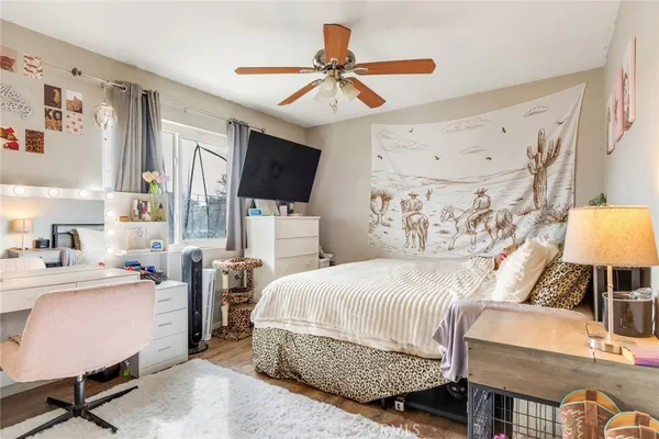 a bedroom with a bed a chair and a chandelier