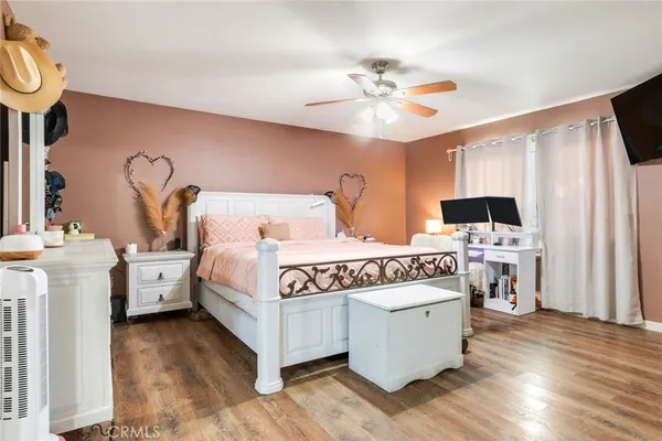 a view of a bedroom with furniture and flat screen tv