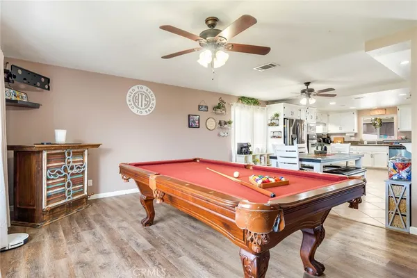 a room with pool table and windows